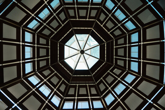 Bottom view of a geometric dome with a central skylight.