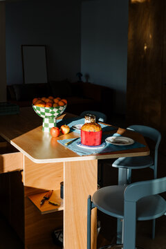 Dining table in an apartment, showing a fruit bowl and bread