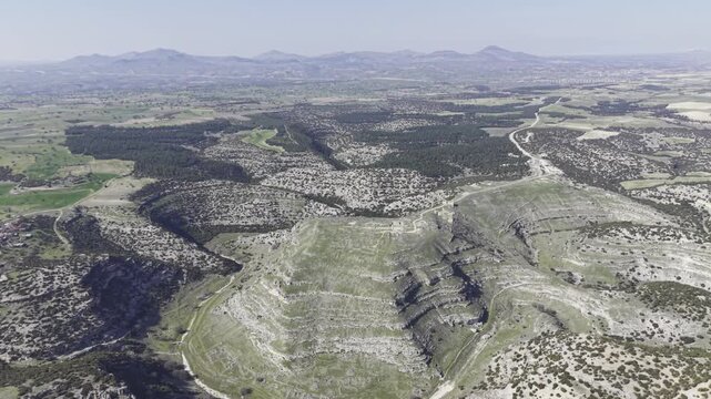 Cinematic aerial drone video footage of Blaundus Ancient City near Ulubey in Usak, Turkey, featuring ancient ruins, stone structures, and dramatic landscape from above in the Aegean region.