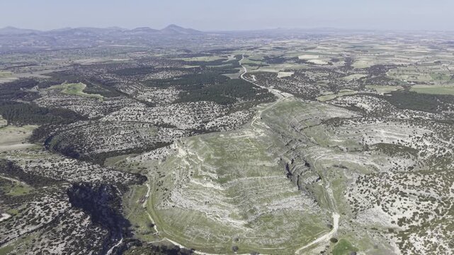 Cinematic aerial drone video footage of Blaundus Ancient City near Ulubey in Usak, Turkey, featuring ancient ruins, stone structures, and dramatic landscape from above in the Aegean region.