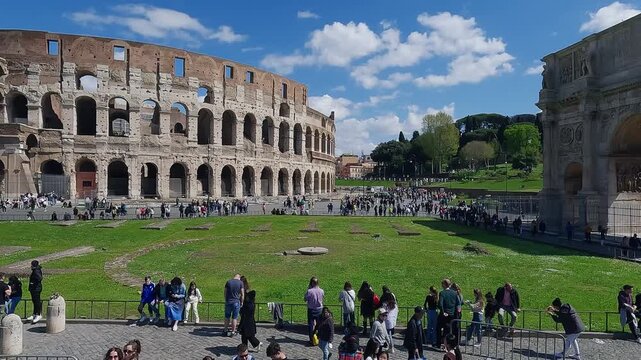 Aerial drone view of ancient Colosseum arena with tourist visitors in Rome, Italy on sunny day