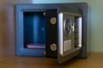 Obraz premium hotel safety box open metal safe in wardrobe minimalist furniture style secure storage for valuables with copy space for banner design concept of travel, hospitality, security