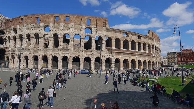 Aerial drone low hight flight shot of Rome, Colosseum, tourist people visitors crowd sightseeing the landmarks of ancient Rome
