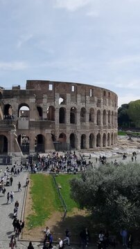 Rome, Italy - 25 May, 2023: Time lapse of crowd of toursit people visiting the famous landmark of Rome an ancient Colosseum arena on sunny summer day, vertical orientation