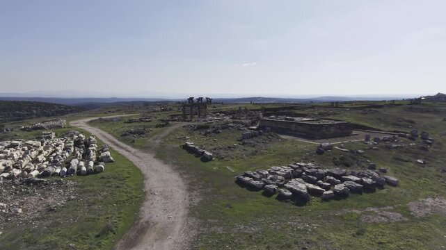 Cinematic aerial drone video footage of Blaundus Ancient City near Ulubey in Usak, Turkey, featuring ancient ruins, stone structures, and dramatic landscape from above in the Aegean region.