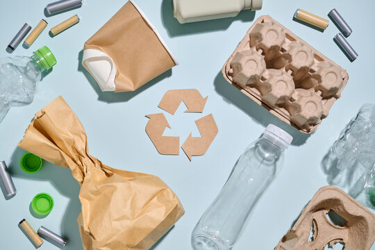 Recycling concept with various waste and the symbol