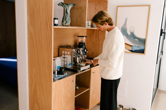 Man relaxing with a latte inside a modern apartment