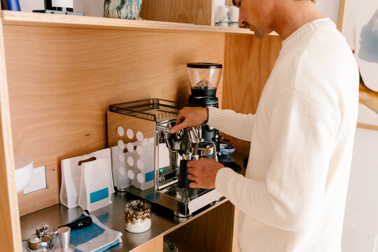 Relaxed man preparing coffee at home on a peaceful morning