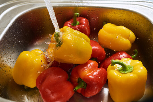 Fresh bell peppers washed under running water