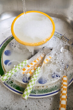 dishes soaking in soapy water