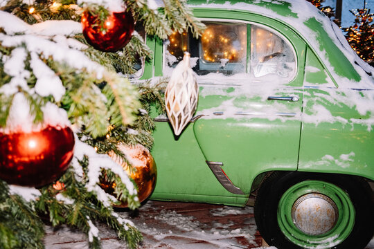 Vintage green car by decorated tree