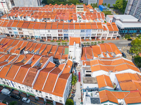 Lines of row houses with terracotta tiled roofs in suburban Singapore