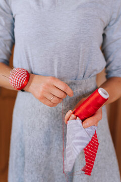 Woman Sewing Colorful Fabric in Cozy Workshop Setting