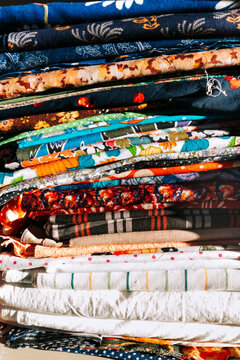 Brightly Colored Fabric Rolls Stacked in a Creative Display