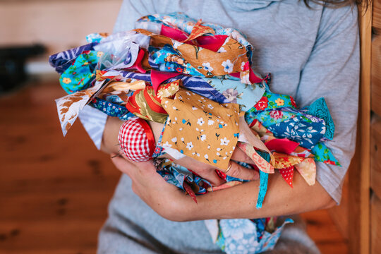 Colorful Patchwork Fabric Wrapped in Cozy Embrace During Crafting Day