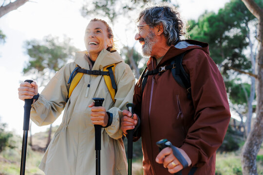 Happy mature couple enjoying hiking in a forest