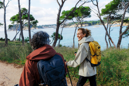 Mature couple hiking coastline enjoying nature adventure