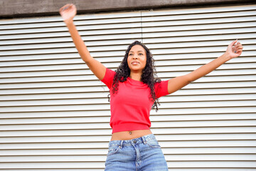 Female figure enthusiastically with arms extended recognizes vibrant and energetic urban atmosphere