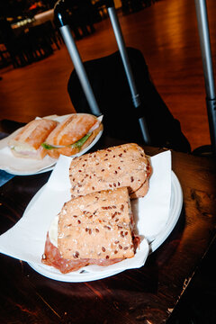 italian panini on a table beside extended suitcase handles