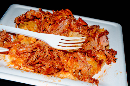 takeaway polenta with pulled pork served on a white plate