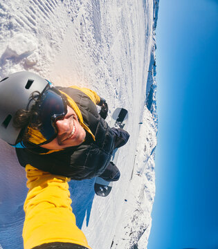 Skier Taking Overhead Selfie While Standing on Snow