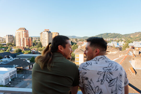 Gay Couple Overlooking City From New Home