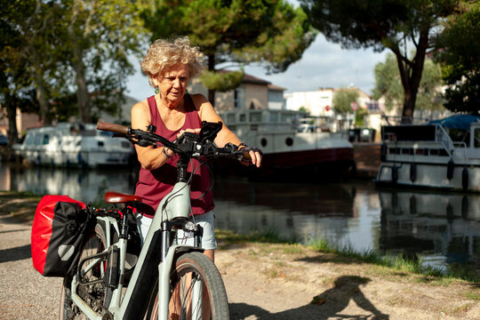 Elderly Woman Using Her Phone While on an Electric Bike Ride