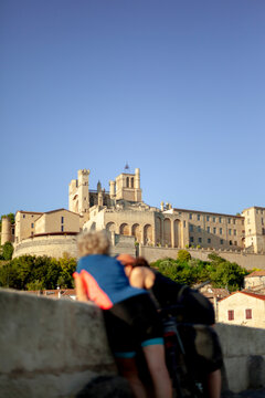 Blurred Cyclists Looking at B&Atilde;&copy;ziers Cathedral