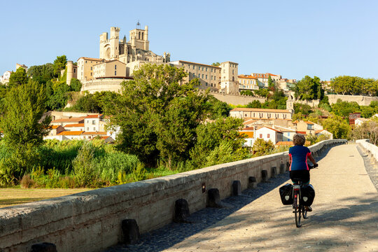 Woman Cycling Toward B&Atilde;&copy;ziers Cathedral