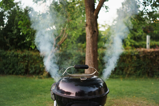 Smoke rises from a barbecue grill