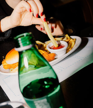 Anonymous girl holding a crispy fried chicken cheese burger