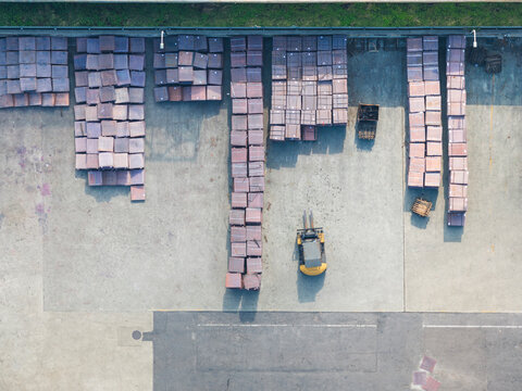 Forklift Moving Cargo Boxes in Industrial Warehouse Aerial View