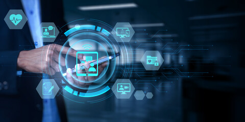 Fototapeta premium Person using a mobile phone with a futuristic holographic interface displaying various medical and technological icons for digital health and connectivity in a modern office environment