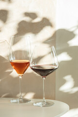 Rose and Red Wine Glasses under Sunlight. Elegant Spring Still Life