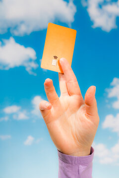 Orange contactless card held vertically