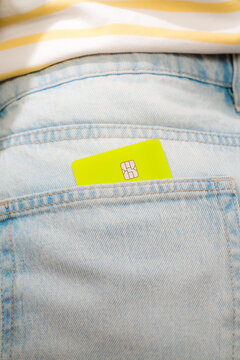 Single green chip card in denim pocket