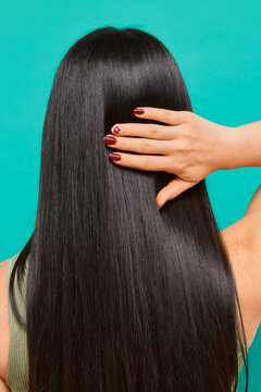 Straight long hair and manicured hand with floral nail art