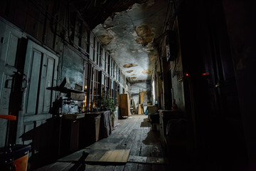 Fototapeta premium Dark corridor of old shabby wooden house