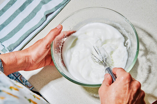 a man whisking egg whites to soft peaks