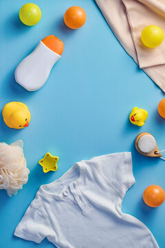 Baby essentials and toys arranged on a blue background