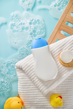 Baby bath time essentials with bubbles and rubber duckies.