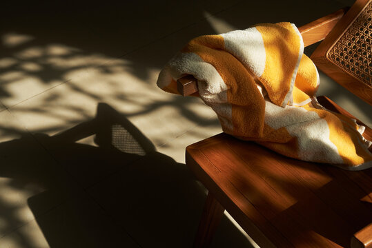Towel thrown on wooden chair