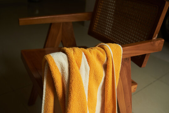 Striped towel draped over a chair