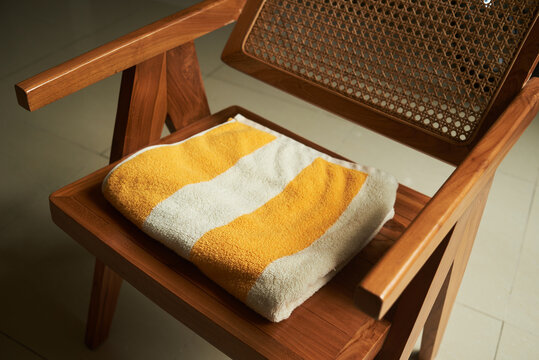 Neatly folded towel on a chair