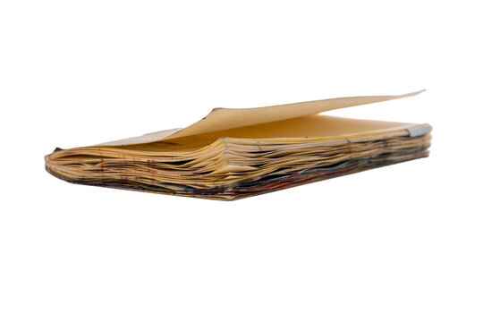 A vintage book with worn pages displayed from the side, highlighting its texture and age. Ideal for conveying nostalgia, literature, or historical themes in design projects.