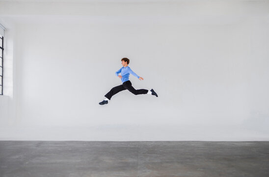 Energetic Leap of a Man Jumping in Studio