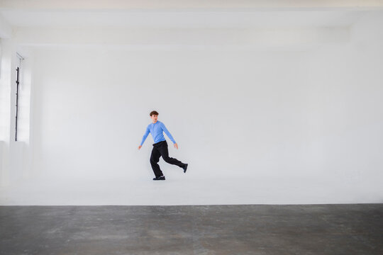 Young Man Dancing In Bright Studio Space