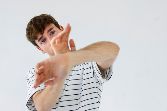 Young Man Stretching Pose in Striped Shirt
