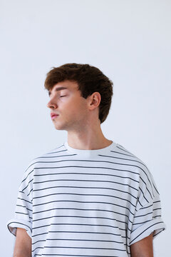 Young Man With Striped Shirt And Closed Eyes