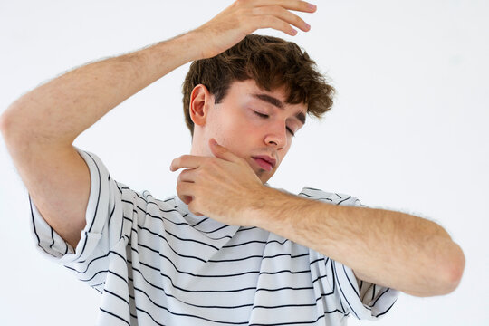 Young Man Dances With Hands Raised